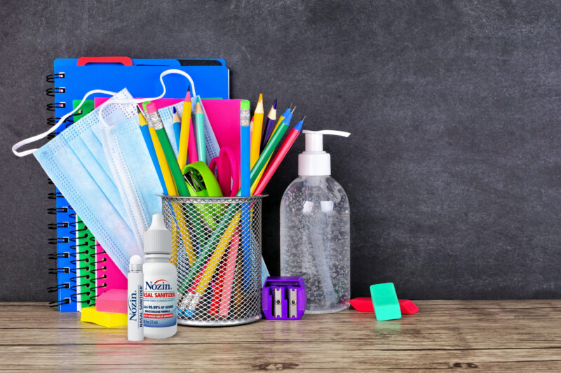 school supplies and infection prevention supplies on a desk
